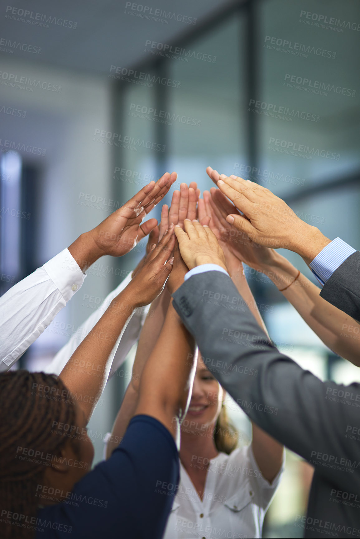 Buy stock photo Shot of a group of unrecognizable businesspeople with their hands in a huddle