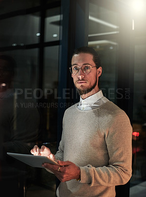 Buy stock photo Portrait of a handsome young designer working late in the office