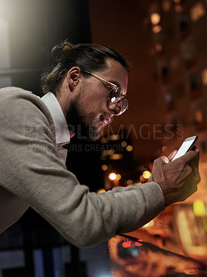 Buy stock photo Phone, city and business man at night for research, internet website and social media on balcony. Technology, communication and male with smartphone for writing email, networking and chatting online