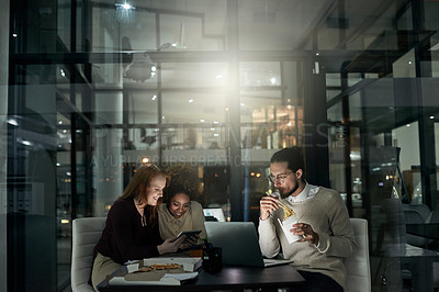 Buy stock photo Night business, people and eating fast food in office with technology, planning and collaboration. Young employees, eating and working late online in dark agency, creative company and diversity group