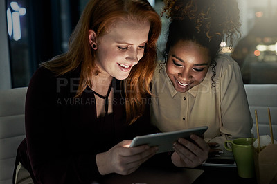 Buy stock photo Shot of two young designers working late in the office
