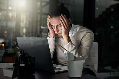 Buy stock photo Cropped shot of a young designer looking stressed while working late in an office