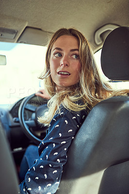 Buy stock photo Cropped shot of an attractive young woman driving a car
