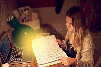 Buy stock photo Shot of a young woman using her laptop in her bedroom at night