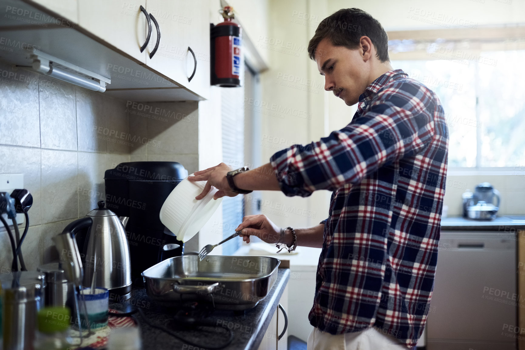 Buy stock photo Cooking, student and man with food for meal prep, nutrition and frying leftover ingredients for lunch. Diet, house and home chef person at kitchen counter with fork, recipe and roasting for dinner