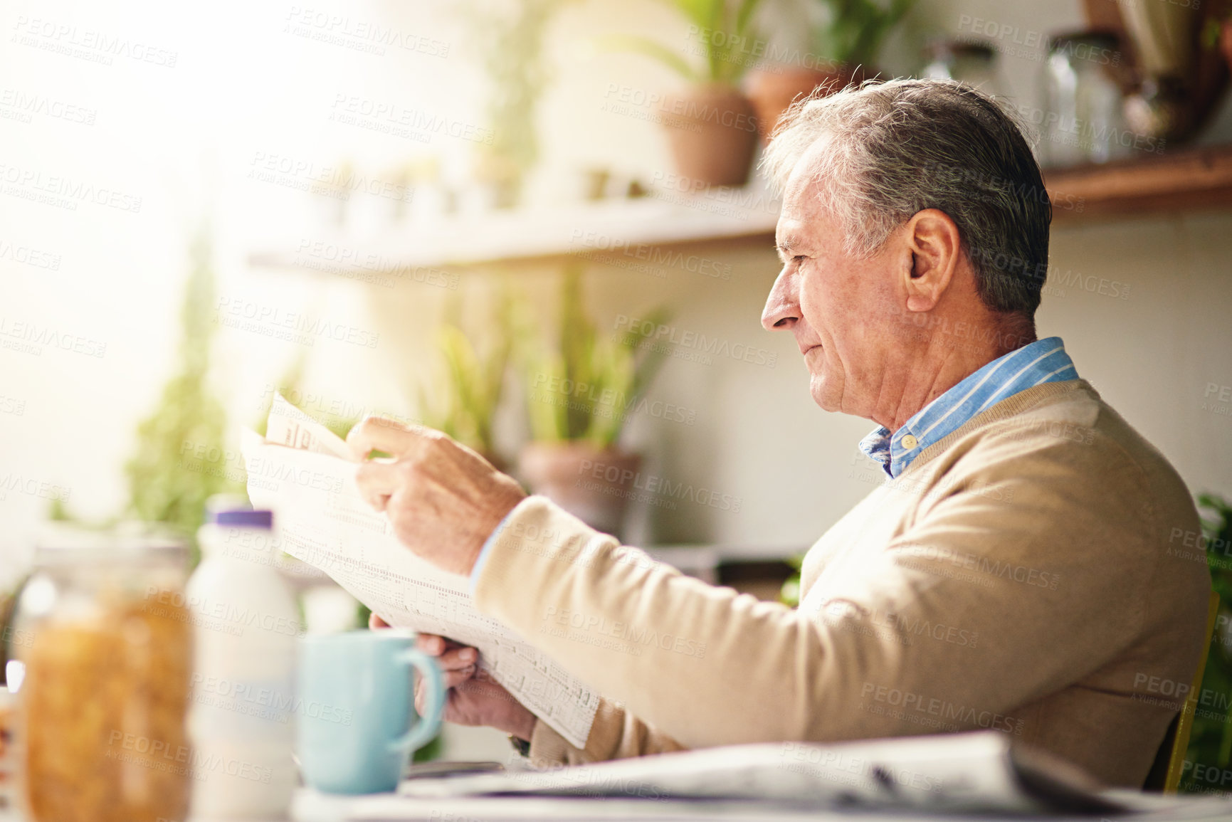 Buy stock photo Cropped shot of a senior man reading a newspaper with his breakfast outdoors