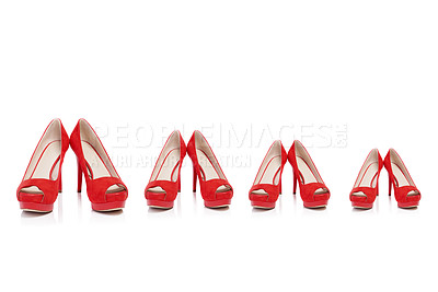 Buy stock photo Shot of a pair of high heels in different sizes in a row isolated on white