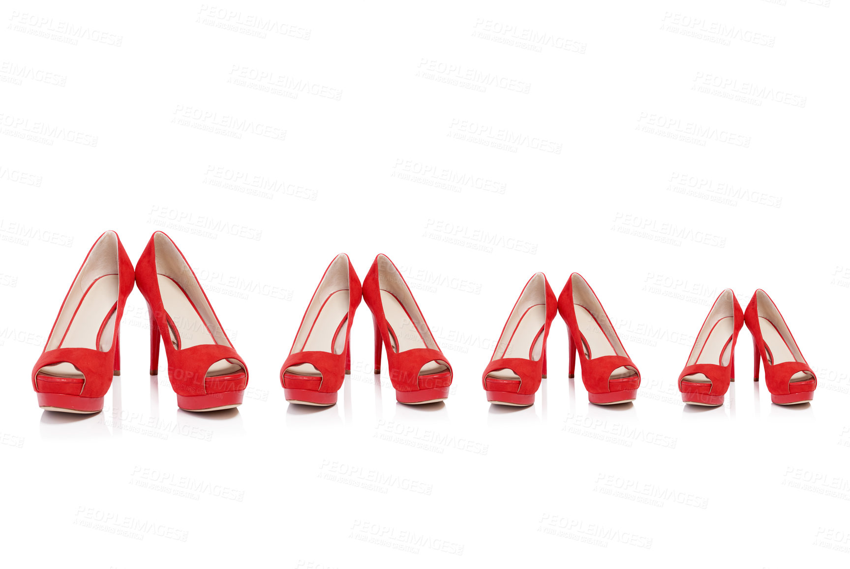 Buy stock photo Shot of a pair of high heels in different sizes in a row isolated on white