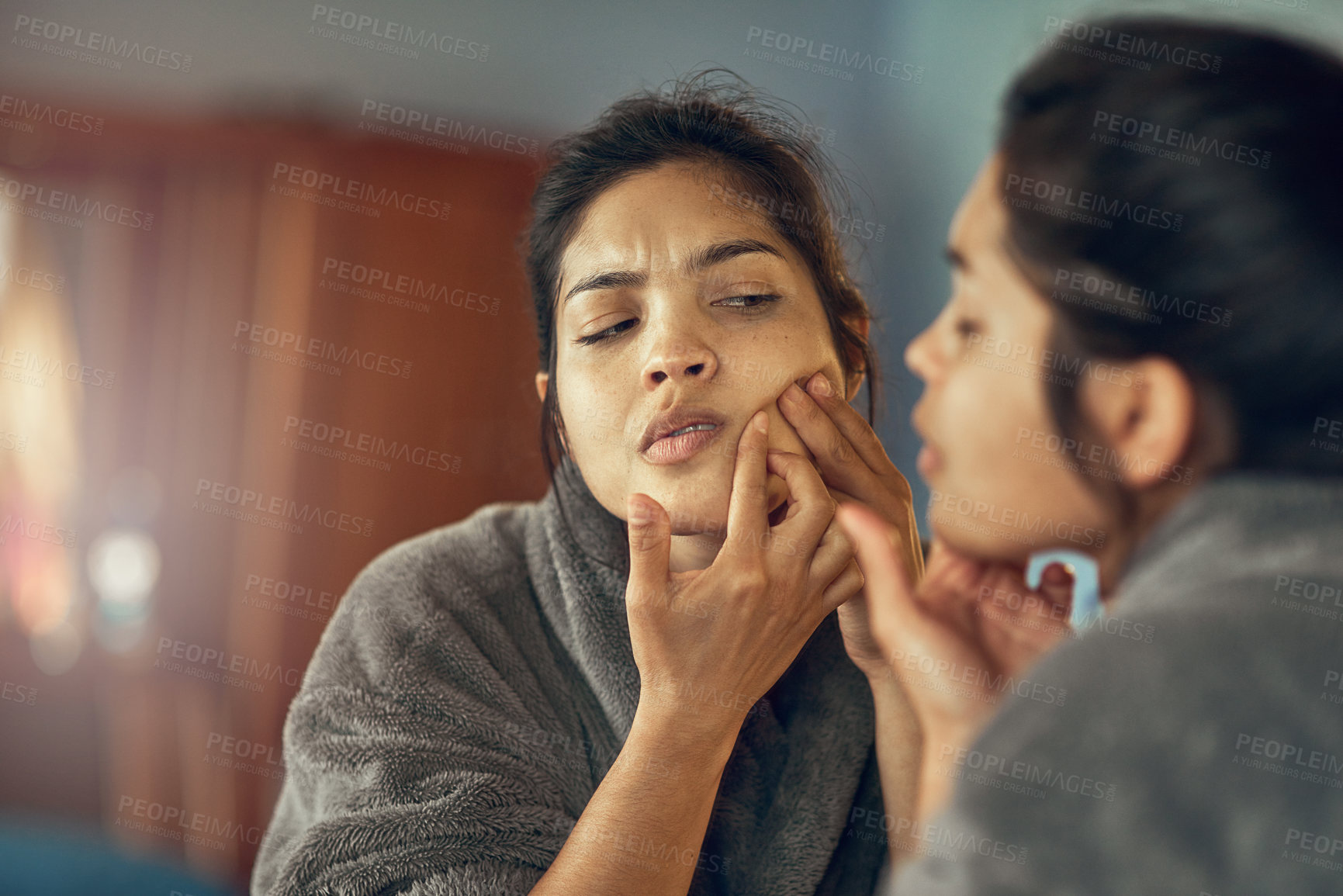 Buy stock photo Skincare, mirror and woman pop pimple in bedroom at home for clean or smooth facial treatment. Reflection, cosmetic and upset female person pressing blackhead on face for beauty at apartment.