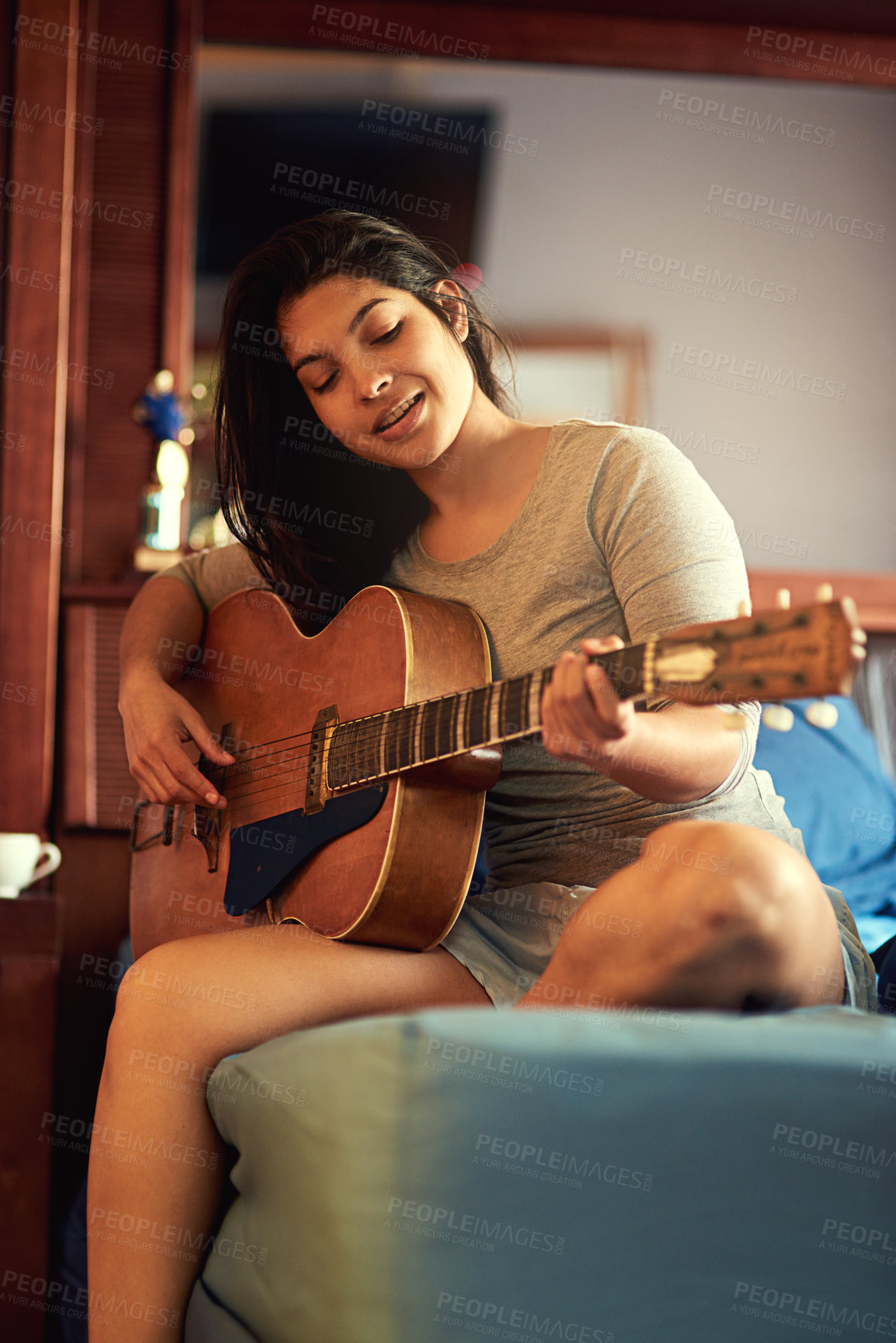 Buy stock photo Guitar, playing and woman musician on bed learning song for performance, recital or concert. Musical career, guitarist and female person with string instrument for hobby in bedroom at home in Mexico.