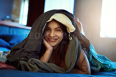 Buy stock photo Clothes, stack and portrait of woman on bed for spring cleaning, lazy and laundry day at home. Happy, female person and face with fabric material in house for messy, comfort and break in housekeeping