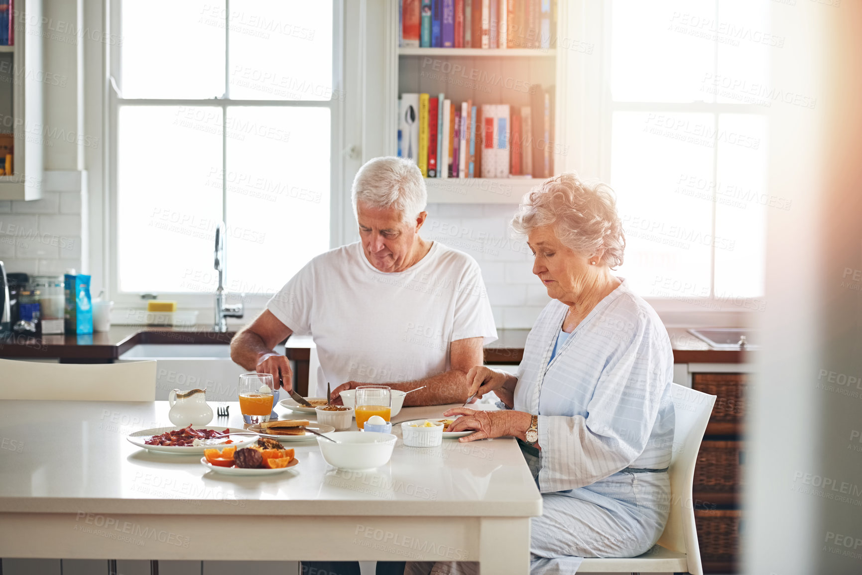 Buy stock photo Cropped shot of a senior couple having breakfast together at home