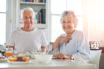 Buy stock photo Portrait of a senior couple having breakfast together at home