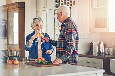 Buy stock photo Shot of a smiling senior couple cooking together in their kitchen at home