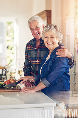 Buy stock photo Portrait of a senior couple cooking together in their kitchen at home