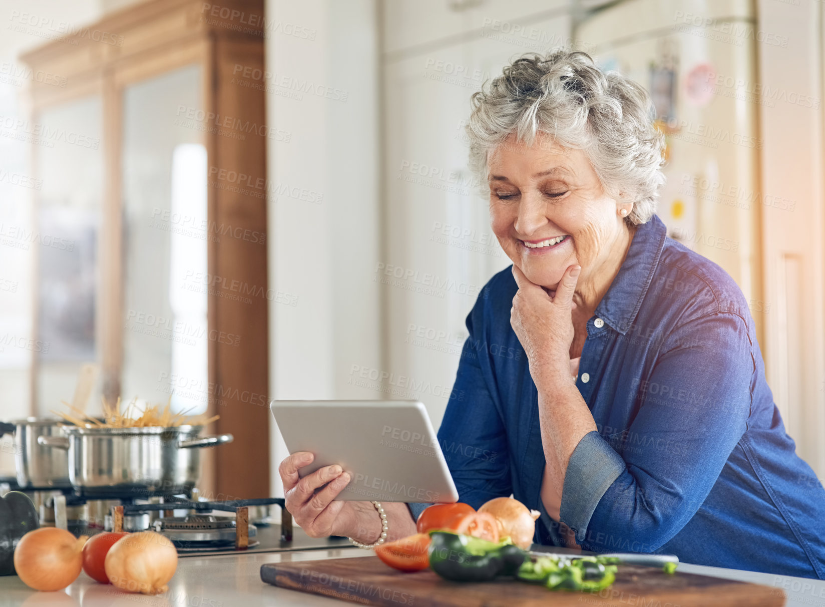 Buy stock photo Tablet, cooking vegetables or happy old woman in kitchen while online for learning on recipe blog at home. Smile, healthy food or senior person on digital app to search for a vegan diet on website