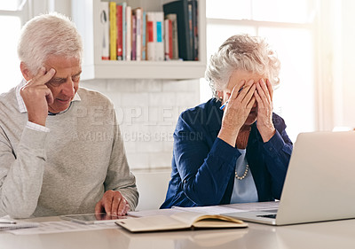 Buy stock photo Cropped shot of a senior couple looking anxious while working on some paperwork