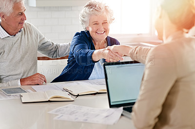 Buy stock photo Cropped shot of a senior couple meeting with their financial consultant