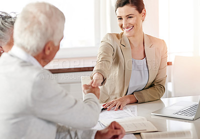 Buy stock photo Cropped shot of a senior couple meeting with their financial consultant