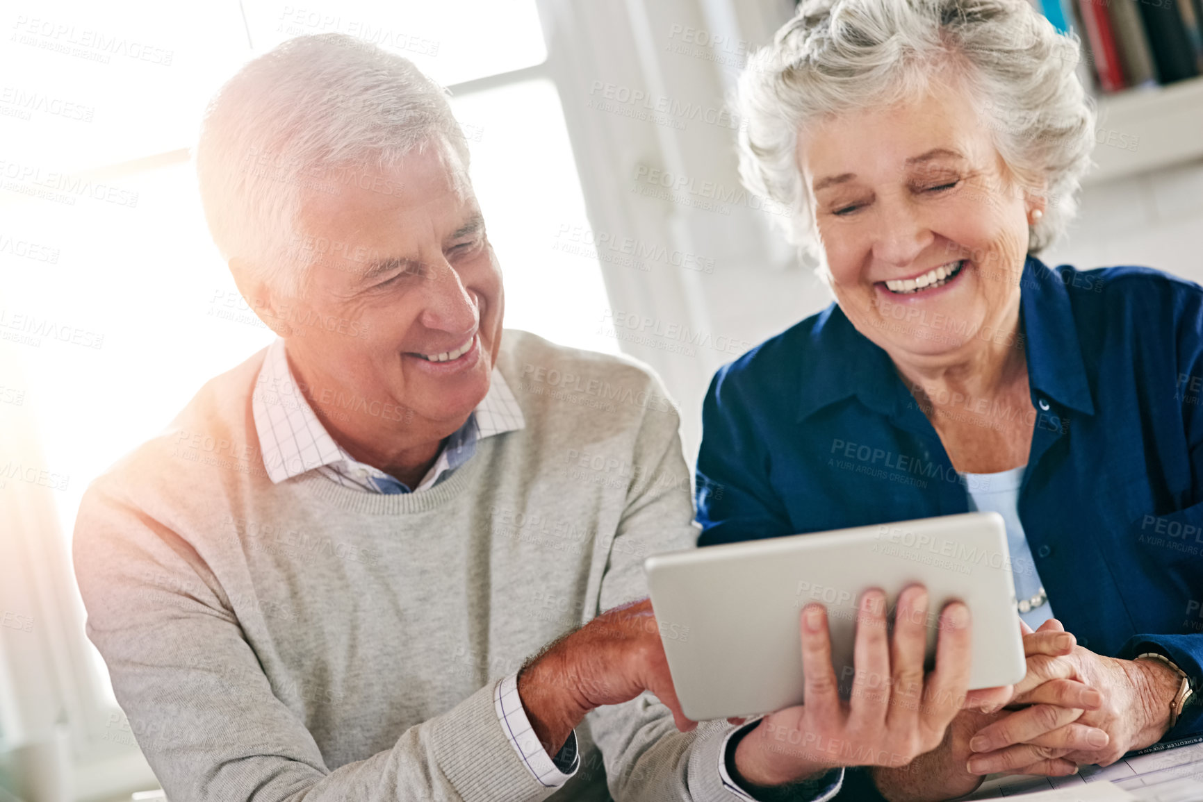 Buy stock photo Cropped shot of a senior couple using a digital tablet together at home