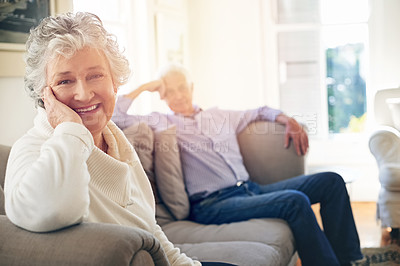 Buy stock photo Portrait of a senior woman relaxing at home with her husband in the background