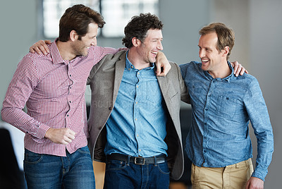 Buy stock photo Teamwork, friendship and support with colleagues standing together in a huddle laughing and feeling happy in a creative office. Business men embracing each other sharing trust, joy and unity