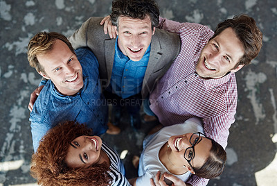 Buy stock photo Cheerful, united and diverse group of young business colleagues in collaboration for corporate trust building. Top view of coworkers looking up, smiling and standing close together.
