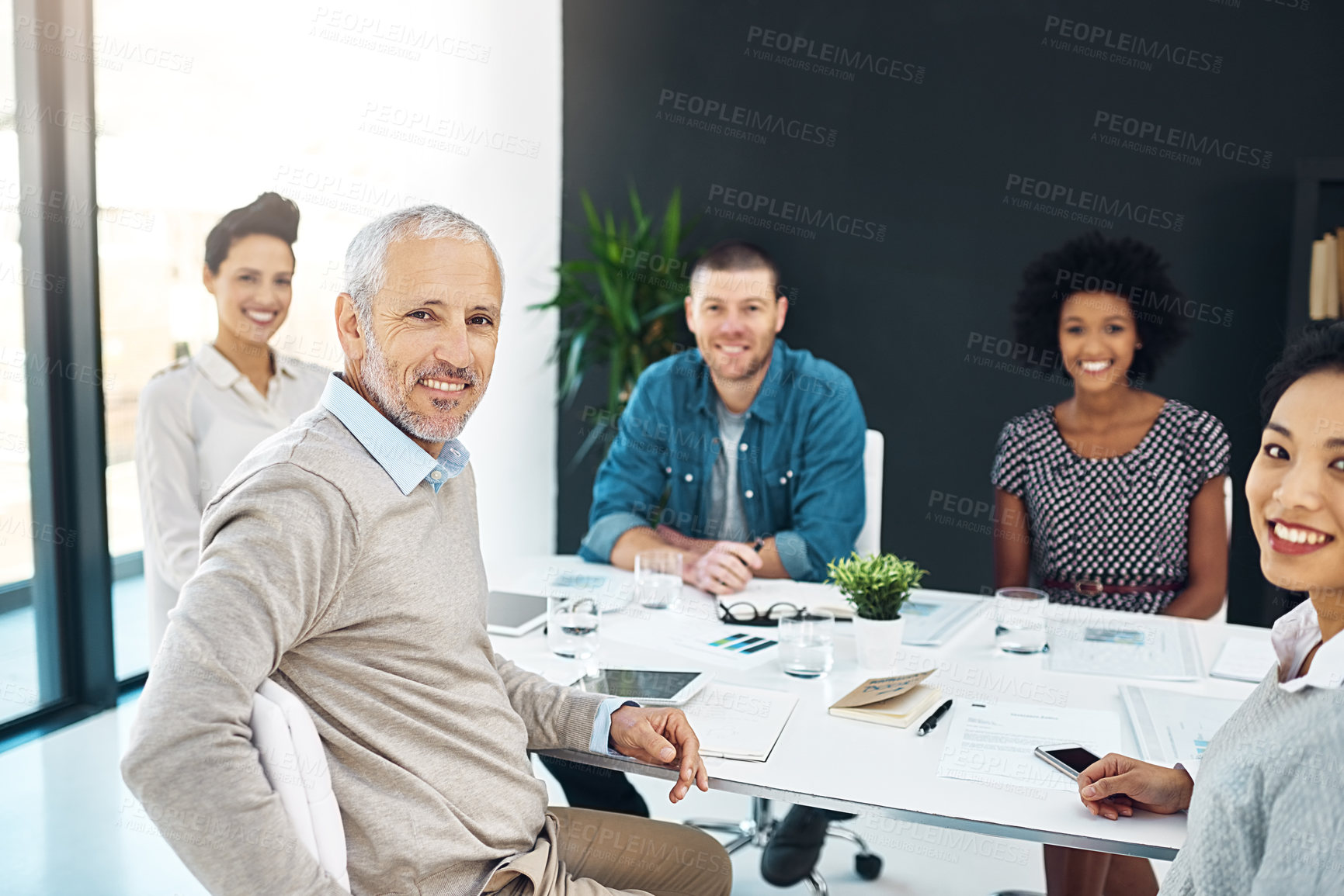 Buy stock photo Portrait, mature man and manager with team in office meeting, about us and leadership in creative business startup. Face, smile and professional executive, ceo and financial advisor with staff group