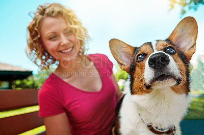 Buy stock photo Shot of a young woman bonding with her dog in the park