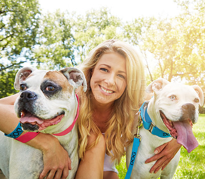 Buy stock photo Shot of a young woman bonding with her dog in the park