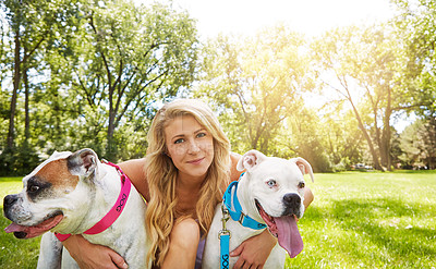 Buy stock photo Shot of a young woman with her two dogs at the park