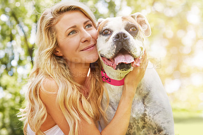 Buy stock photo Shot of a young woman spending time with her dog at the park