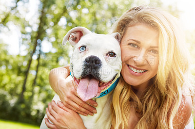 Buy stock photo Shot of a young woman spending time with her dog at the park