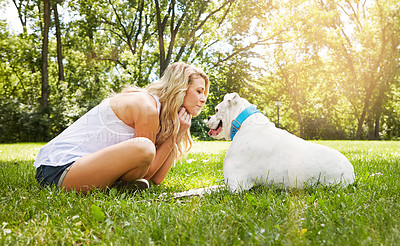 Buy stock photo Shot of a young woman spending time with her dog at the park