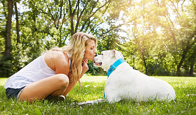 Buy stock photo Shot of a young woman spending time with her dog at the park