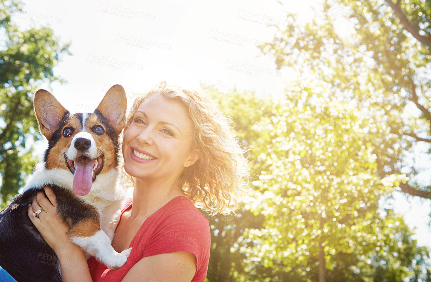 Buy stock photo Shot of a young woman bonding with her dog in the park