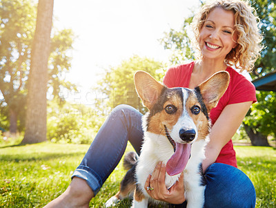 Buy stock photo Shot of a young woman bonding with her dog in the park