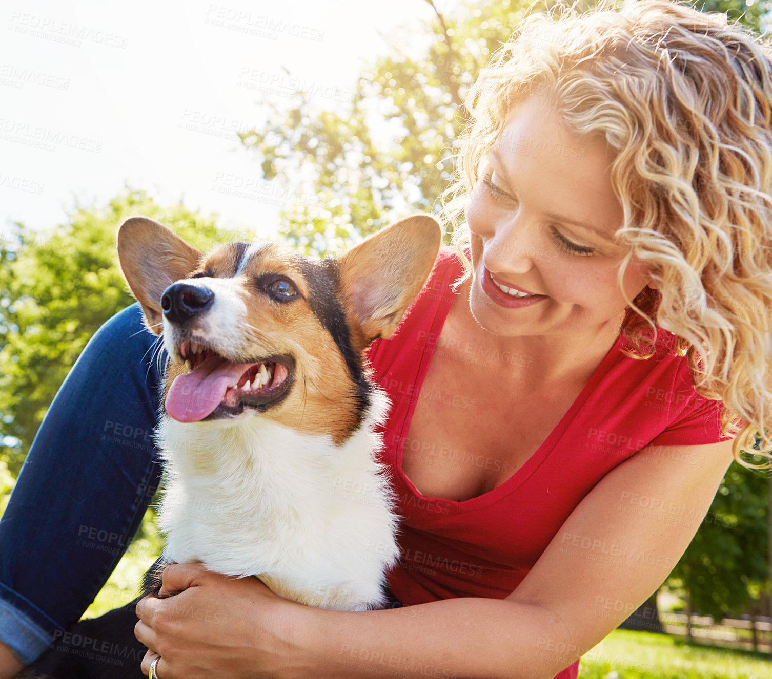 Buy stock photo Shot of a young woman bonding with her dog in the park