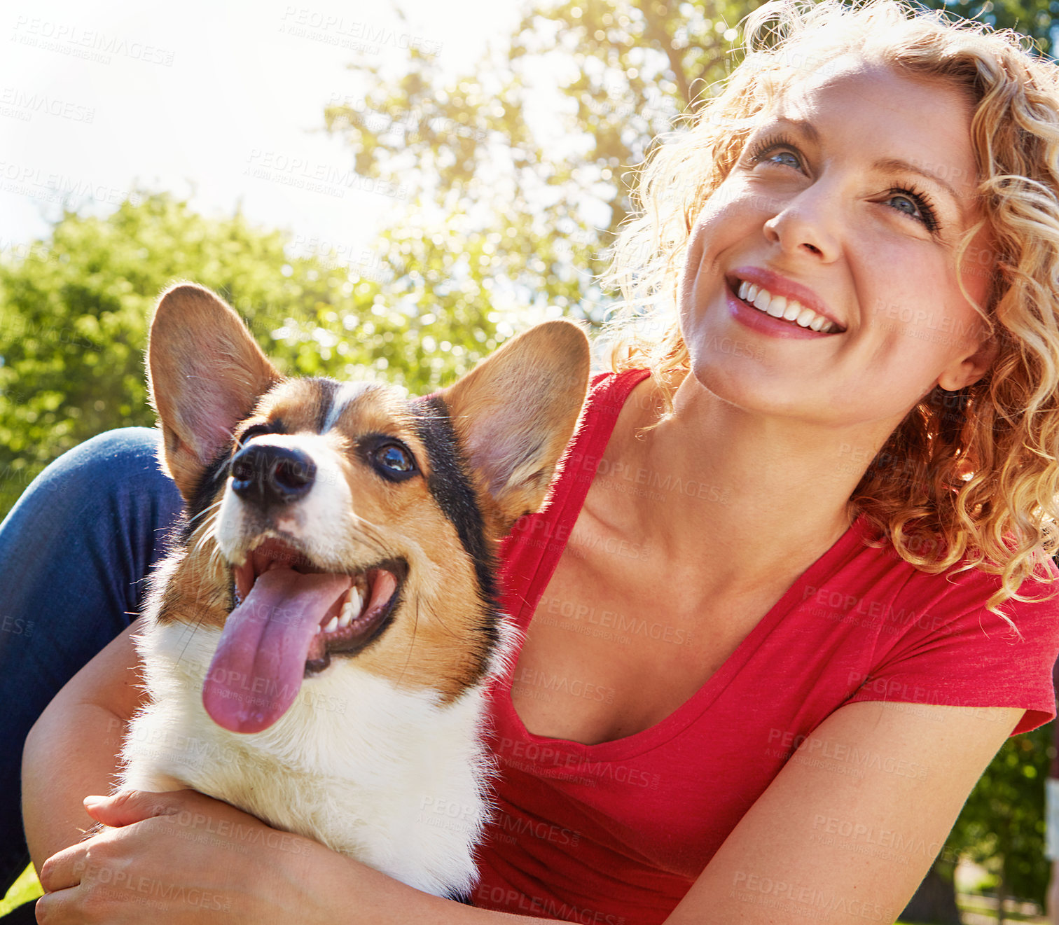 Buy stock photo Shot of a young woman bonding with her dog in the park