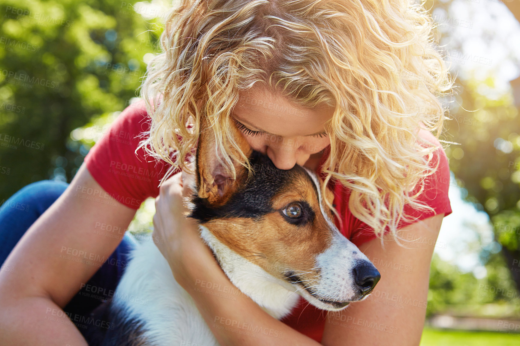 Buy stock photo Shot of a young woman bonding with her dog in the park