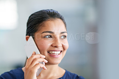 Buy stock photo Shot of an attractive young businesswoman using her cellphone in the office