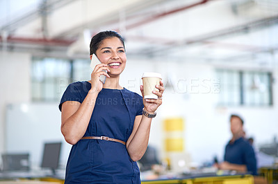 Buy stock photo Shot of an attractive young businesswoman using a cellphone in her office