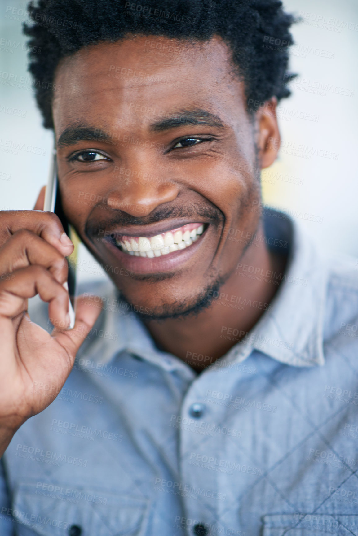 Buy stock photo Happy black man, funny and laughing with phone call for friendly discussion, chat or joke at office. Young African, male person or agent talking on mobile smartphone with smile for fun conversation