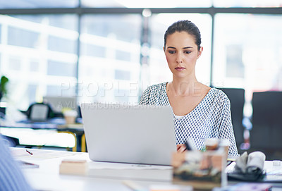 Buy stock photo Shot of an attractive young businesswoman working in a modern office