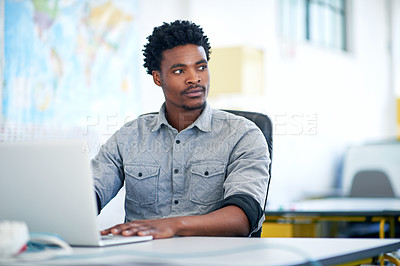Buy stock photo Shot of a handsome young businessman working in a modern office
