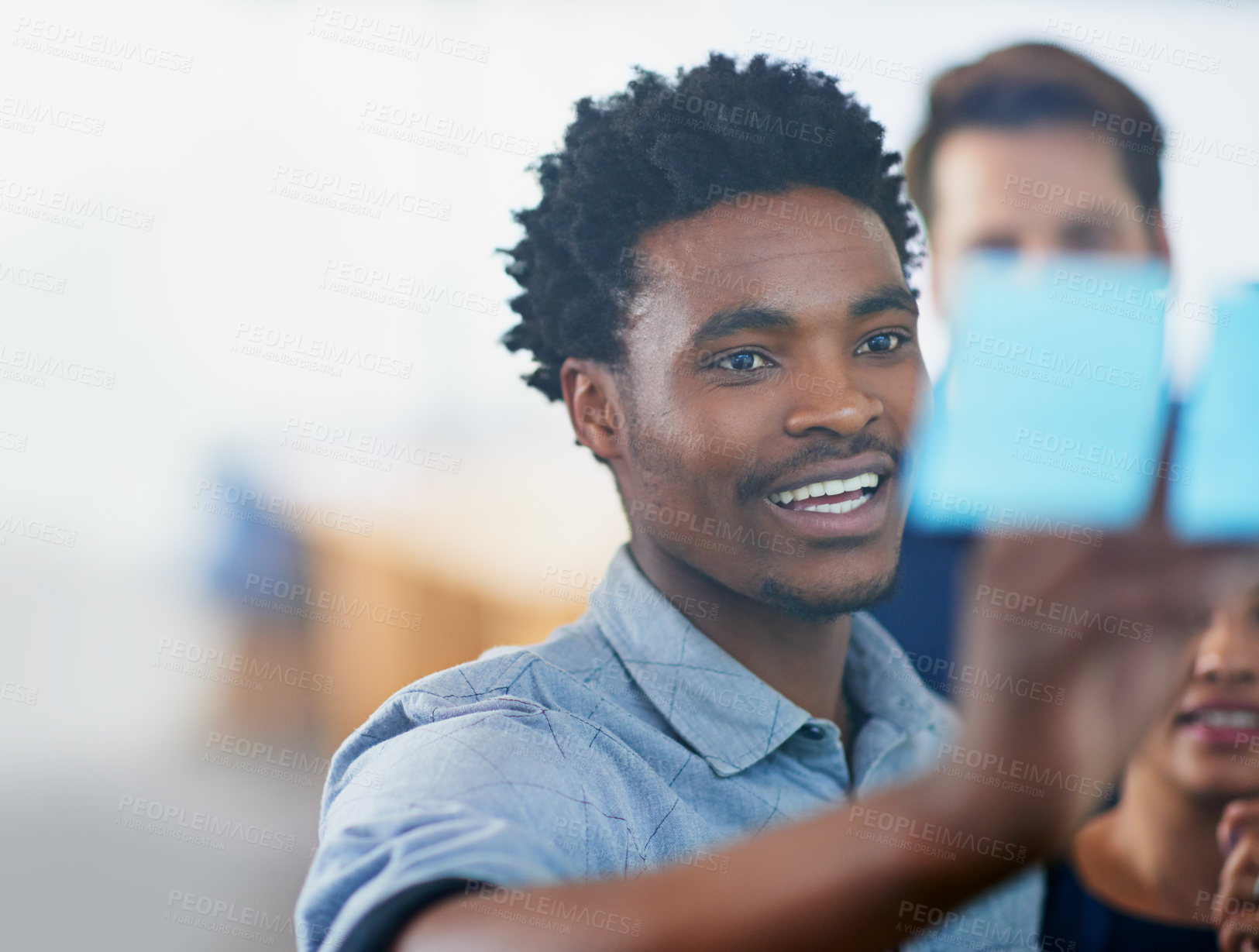 Buy stock photo Glass, wall and black man planning with writing on note in office with team strategy or brainstorming. Creative, thinking or talking with research for mind map, solution or problem solving moodboard