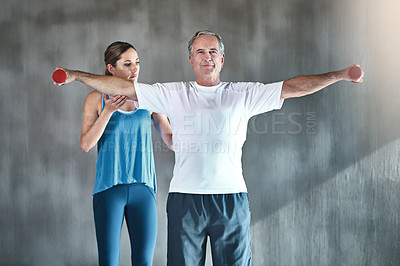 Buy stock photo Physical therapy, dumbbell and fitness with old man and personal trainer for support, health and physiotherapy. Training, weightlifting and coaching with senior patient and female trainer for help
