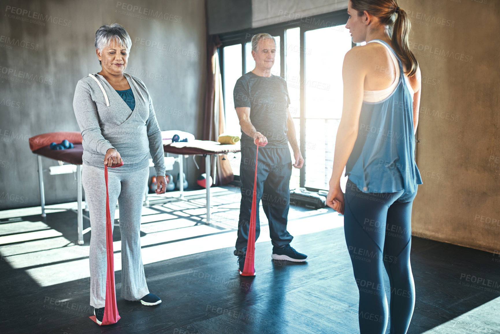 Buy stock photo Stretching band, physiotherapy and senior people for support and help with legs or muscle training. Exercise, workout and physiotherapist and mature clients in class with physical therapy or wellness