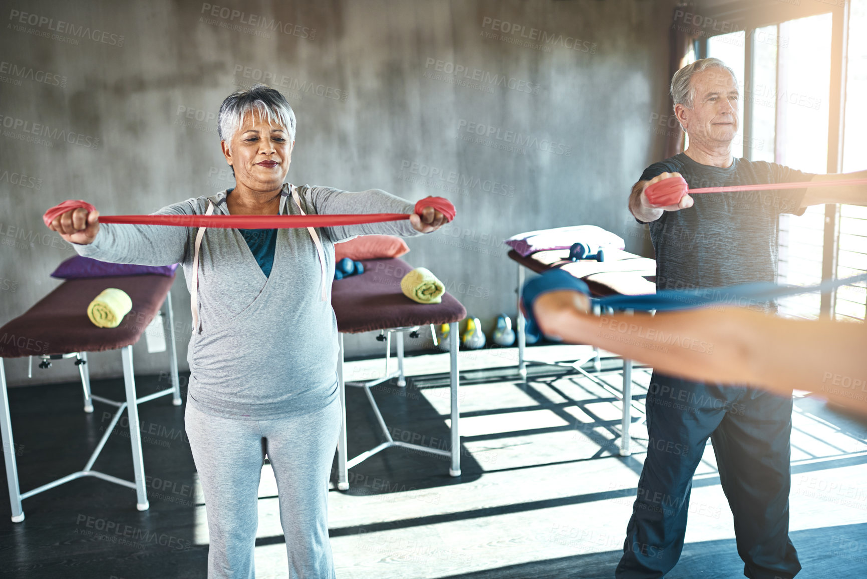 Buy stock photo Stretching band, physiotherapy and senior people for support and help with muscle fitness by physiotherapist. Exercise, workout and strength training of mature clients in class for physical therapy