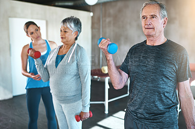 Buy stock photo Physiotherapy, dumbbell and mature people with support and muscle workout for recovery or health. Exercise, fitness and woman helping senior clients or patient for physical therapy in wellness class